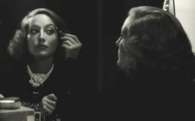 Joan-Crawford-applies-max-Factor-makeup-1934b-696x552